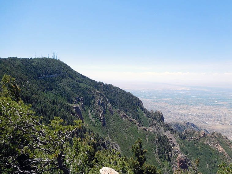  Top of Sandia Peak overlooking Albuquerque and Rio Grande -- July 3, 2o17 -- photo by Mark Weber ---- KUNM's radio tower is among those in the cluster that broadcast all over New Mexico ------ Albuquerque is an island city in the middle of a giant desert -- No other metropolitan area for 500 miles in either direction: El Paso to the south, Denver to the north, Dallas to the east, and Phoenix to the west ----- Nothing but rattlesnakes, scorpions, black widows, wasps, fire ants, yoga fanatics, vampire bats, wolves, cactus, and tarantulas between here and there, only the thorny survive